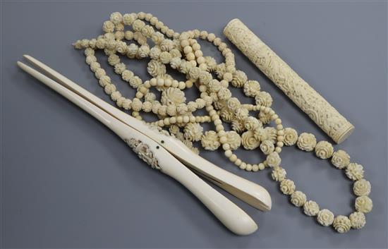 A 19th century Chinese export ivory bodkin case, three ivory bead necklaces and a pair of ivory glove stretchers